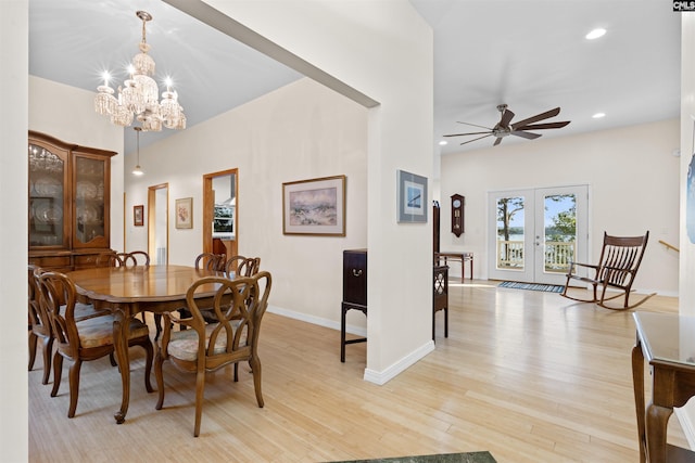 dining space featuring ceiling fan with notable chandelier, light hardwood / wood-style floors, and french doors