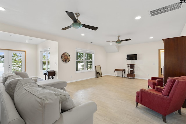 living room featuring french doors, ceiling fan, plenty of natural light, and light wood-type flooring