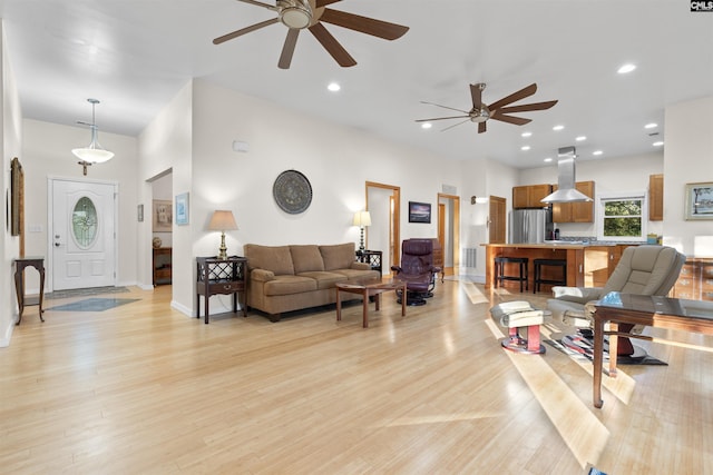 living room featuring ceiling fan and light hardwood / wood-style flooring