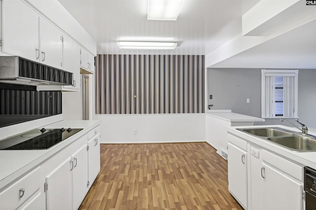 kitchen with sink, white cabinetry, black appliances, exhaust hood, and light wood-type flooring