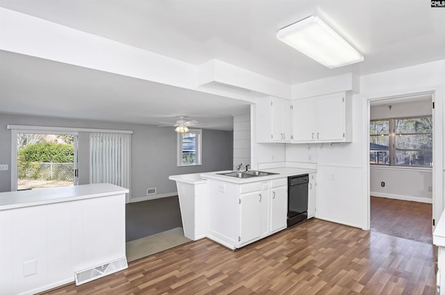 kitchen with white cabinetry, kitchen peninsula, sink, and dishwasher