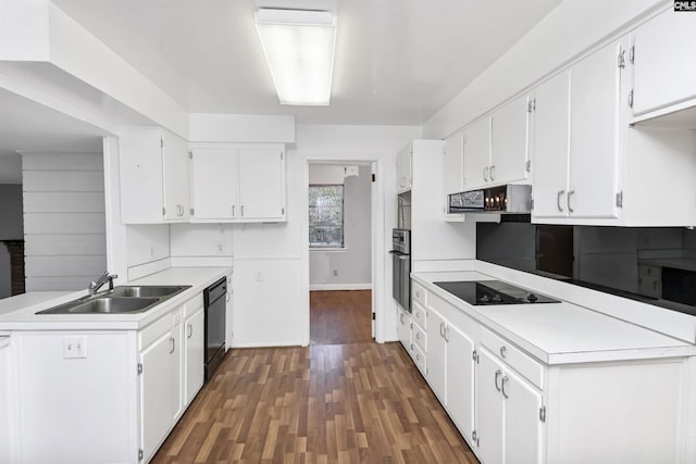 kitchen featuring dark hardwood / wood-style flooring, black appliances, range hood, and white cabinets