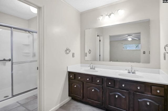 bathroom featuring vanity, a shower with door, and a textured ceiling