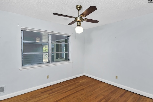 empty room featuring ceiling fan, wood-type flooring, and a textured ceiling