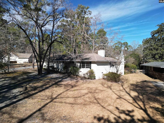 view of side of home featuring a lawn