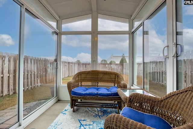 sunroom with vaulted ceiling with beams