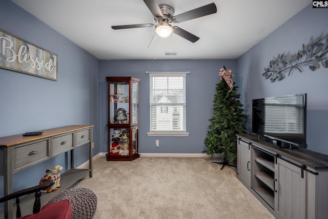 interior space with light colored carpet and ceiling fan