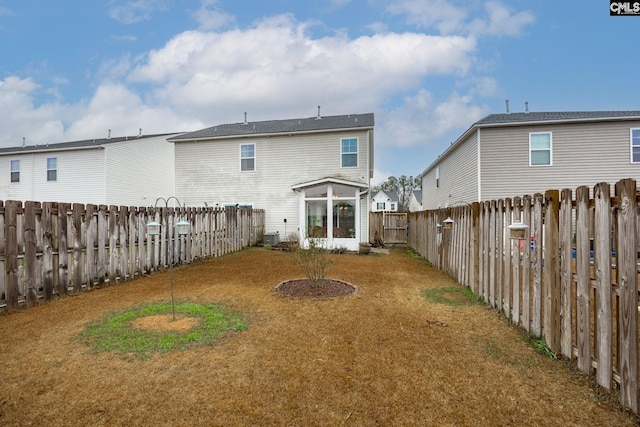 rear view of property with a yard