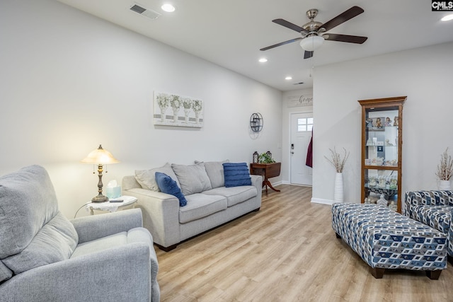 living room with ceiling fan and light wood-type flooring