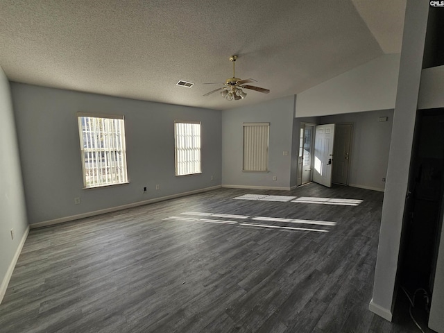 empty room featuring vaulted ceiling, ceiling fan, a textured ceiling, and dark hardwood / wood-style flooring