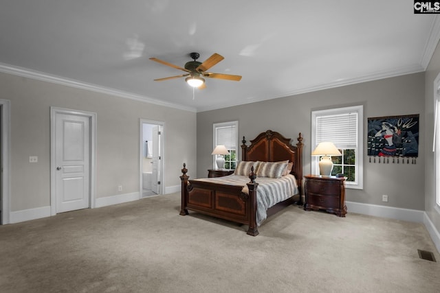 carpeted bedroom featuring ceiling fan, ensuite bath, and ornamental molding