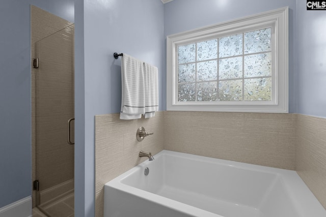 bathroom with separate shower and tub