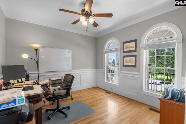 home office featuring crown molding, a wealth of natural light, and light wood-type flooring