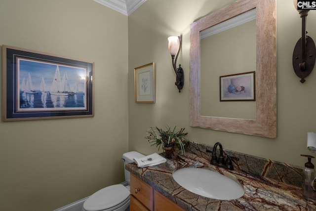 bathroom featuring vanity, crown molding, and toilet