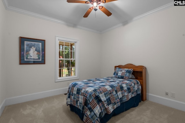 bedroom featuring ornamental molding, light colored carpet, and ceiling fan