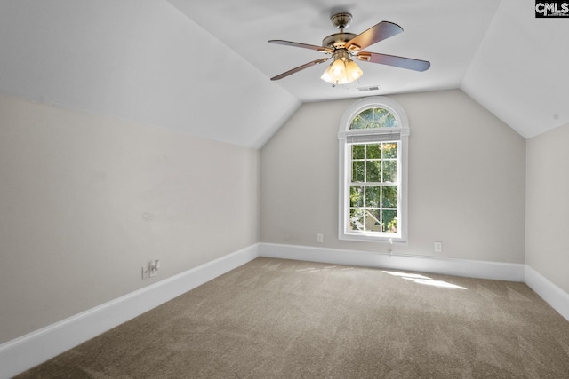 additional living space with lofted ceiling, light colored carpet, and ceiling fan