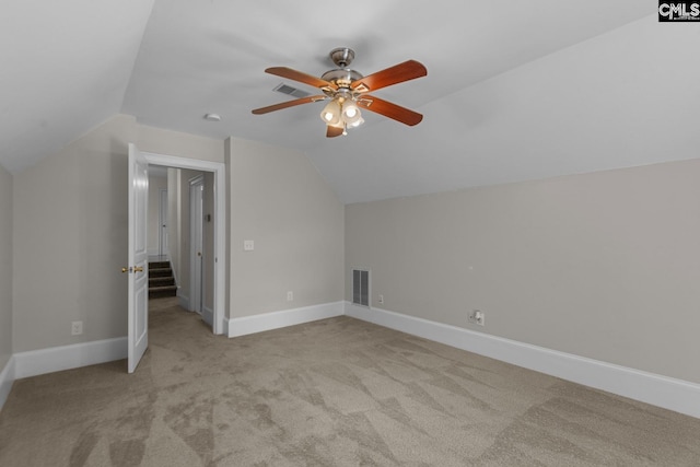 bonus room with light carpet, vaulted ceiling, and ceiling fan