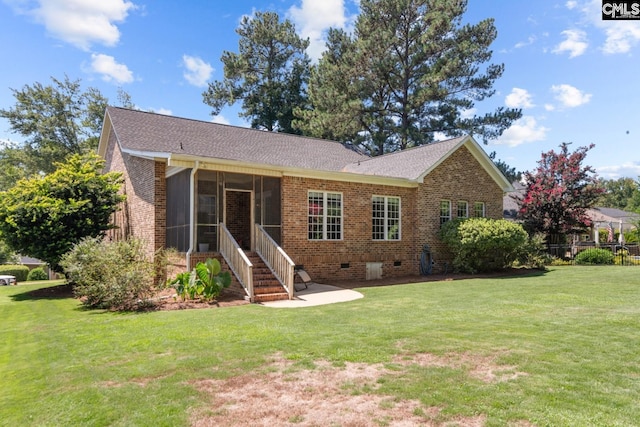 back of house with a yard and a sunroom