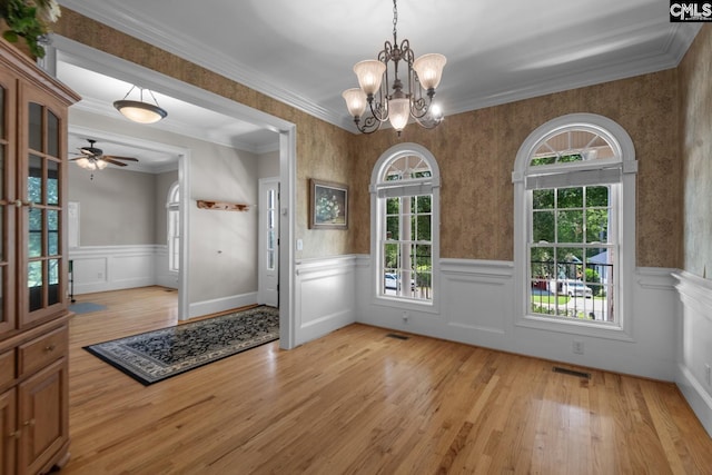 interior space featuring crown molding, ceiling fan with notable chandelier, and light hardwood / wood-style floors