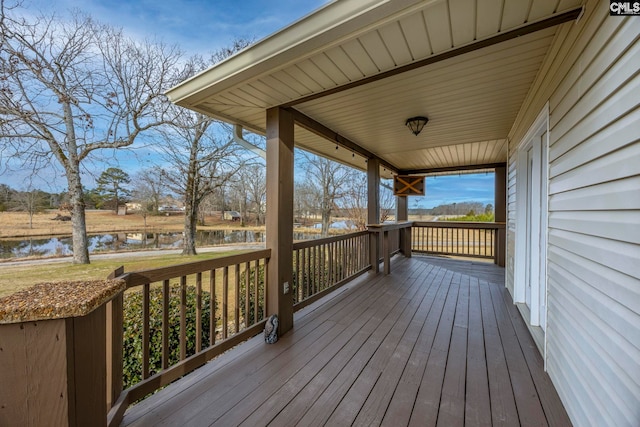 wooden terrace featuring a water view