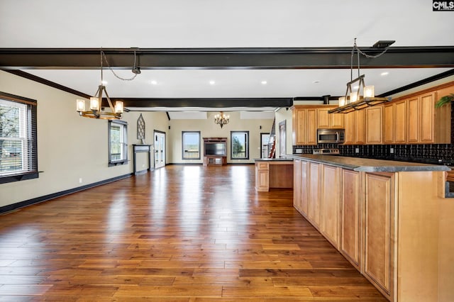 kitchen featuring hardwood / wood-style flooring, decorative backsplash, an inviting chandelier, and decorative light fixtures