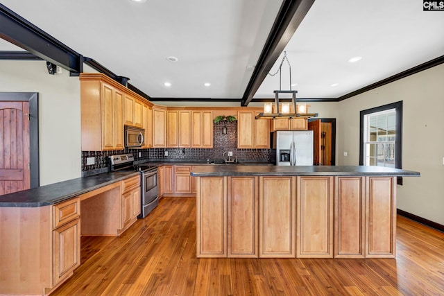 kitchen featuring tasteful backsplash, appliances with stainless steel finishes, and a center island