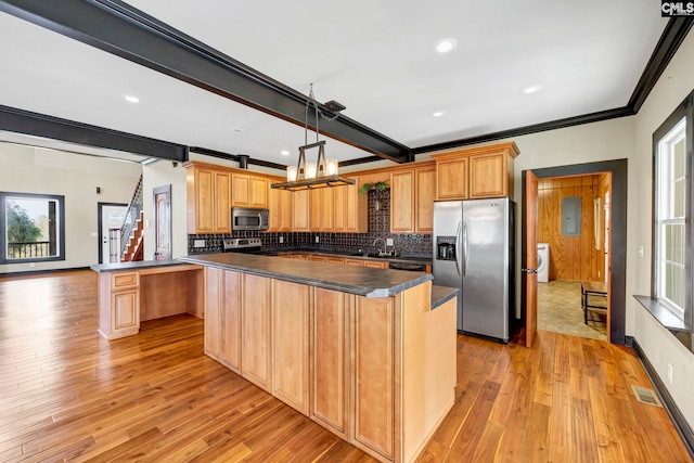 kitchen with pendant lighting, beamed ceiling, decorative backsplash, a center island, and stainless steel appliances