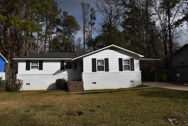 ranch-style home featuring a carport and a front lawn