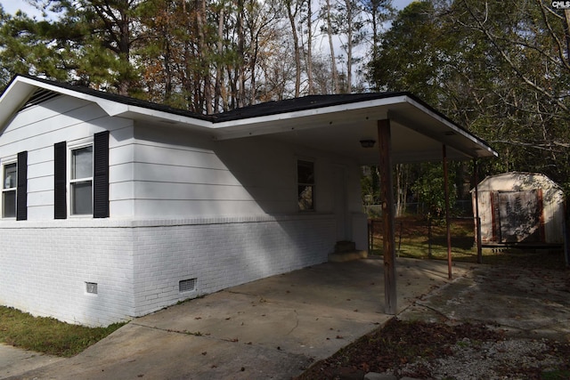 view of property exterior with a carport and a shed