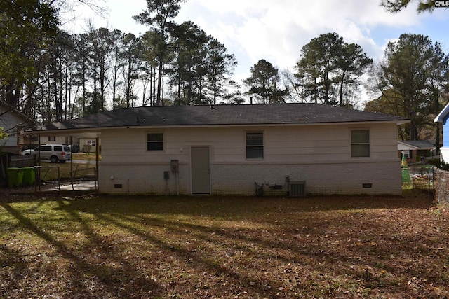 back of house with a yard and central air condition unit