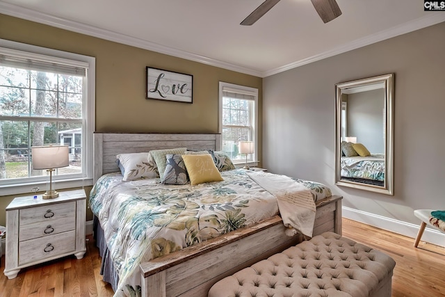 bedroom featuring crown molding, ceiling fan, and light wood-type flooring