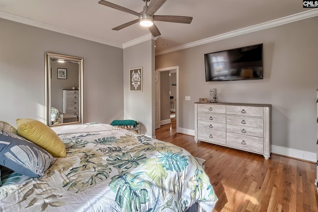 bedroom with hardwood / wood-style flooring, ornamental molding, and ceiling fan