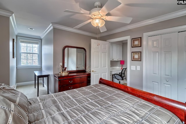 bedroom featuring crown molding, built in desk, ceiling fan, a closet, and light colored carpet