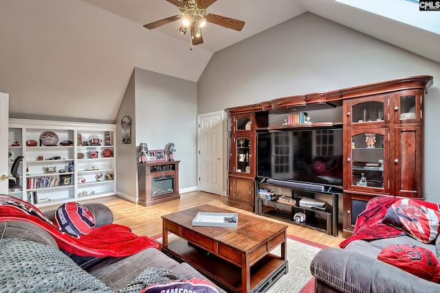 living room featuring ceiling fan, high vaulted ceiling, and light hardwood / wood-style flooring