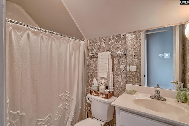 bathroom featuring vanity, vaulted ceiling, and toilet