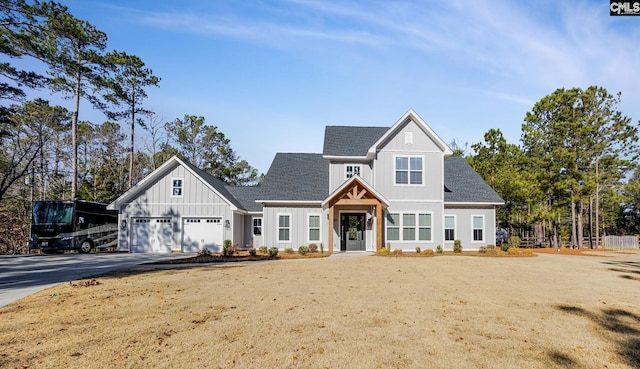 view of front of house with a garage and a front lawn