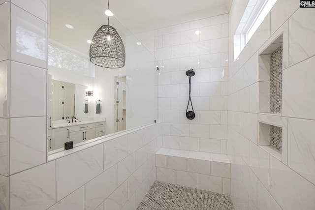 bathroom with vanity and tiled shower