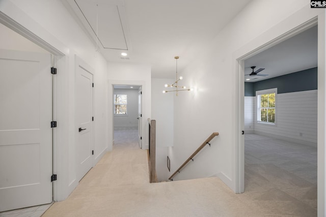 hall featuring light colored carpet