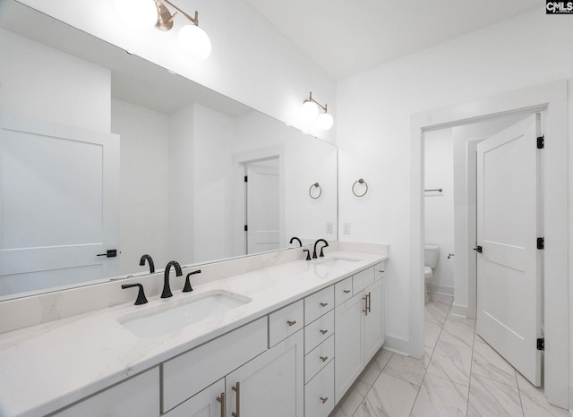 bathroom with vanity and toilet