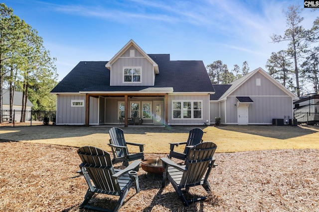 back of property featuring central air condition unit and an outdoor fire pit