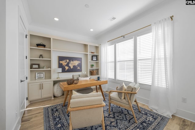 home office with light hardwood / wood-style floors