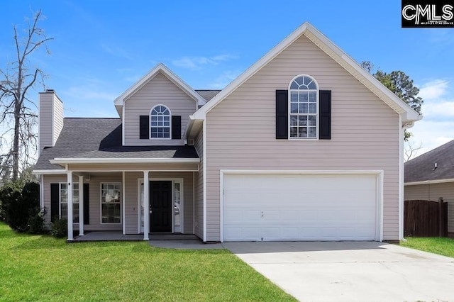 front of property featuring a garage, a front lawn, and a porch