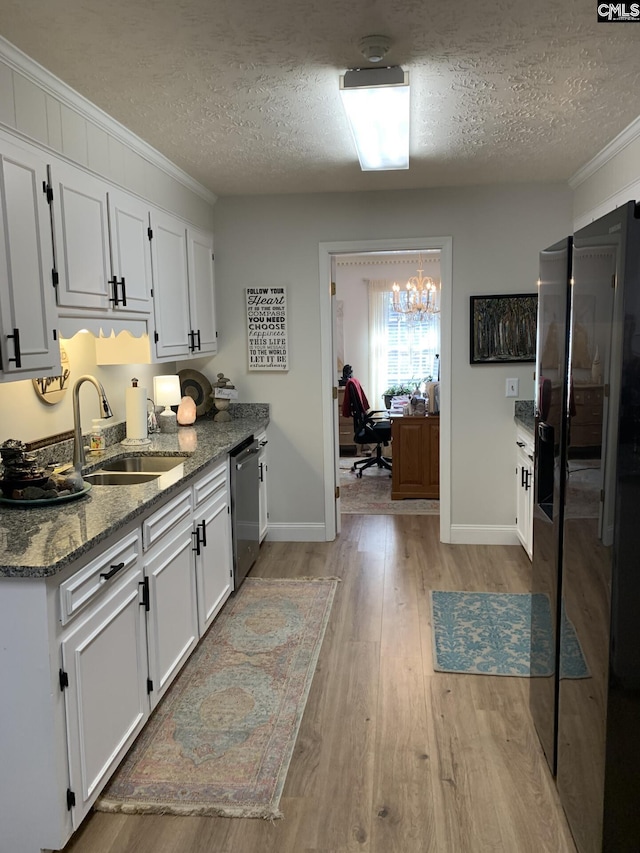 kitchen featuring white cabinetry, stainless steel appliances, light stone countertops, and sink