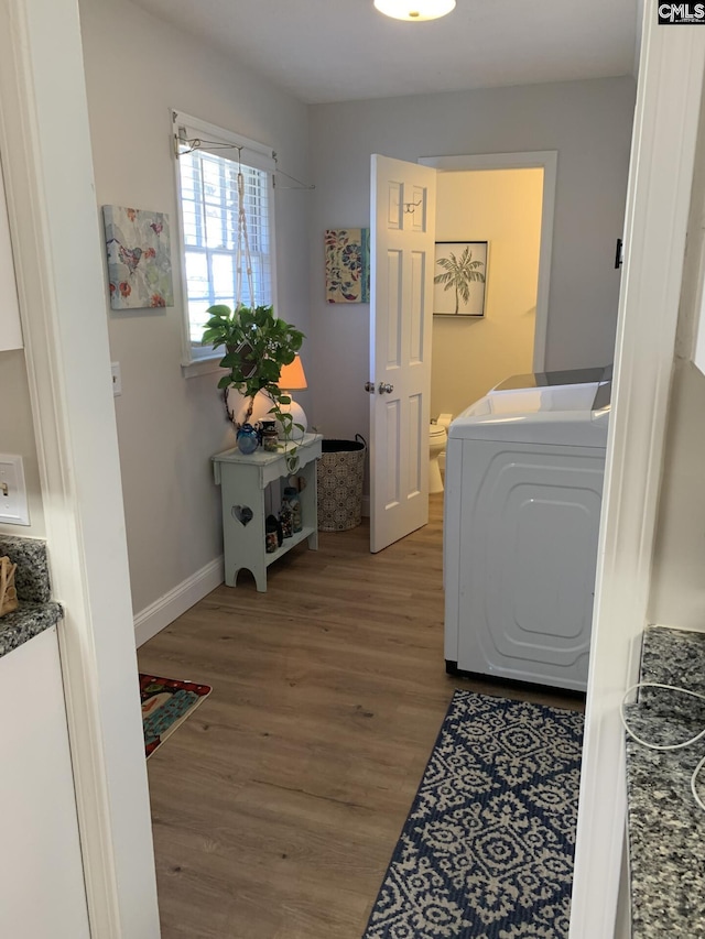 clothes washing area featuring washer / clothes dryer and hardwood / wood-style floors