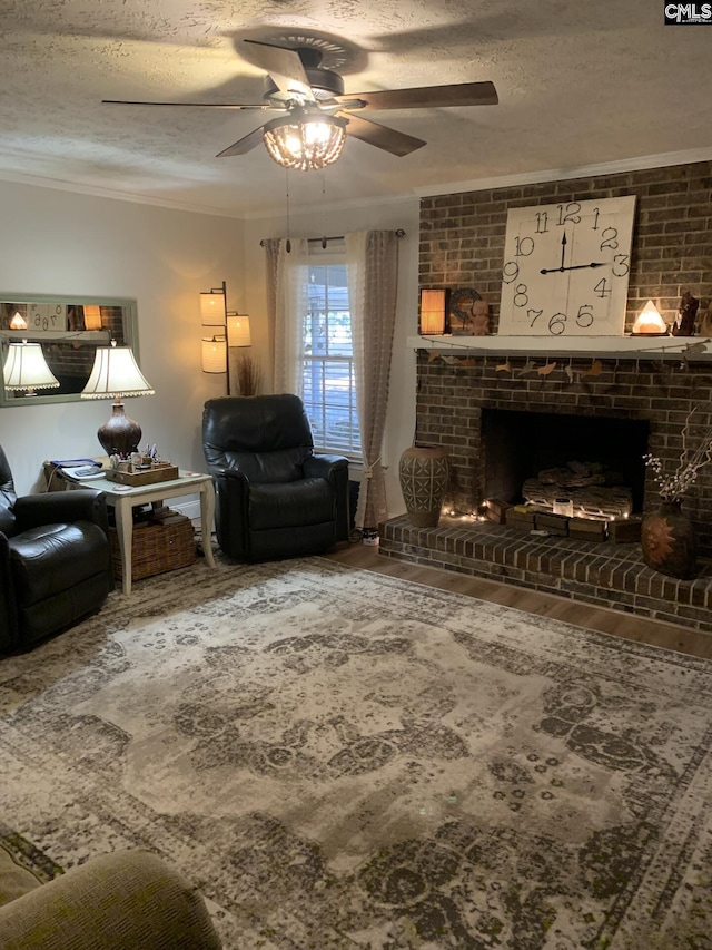 living room with ornamental molding, a brick fireplace, hardwood / wood-style floors, and a textured ceiling