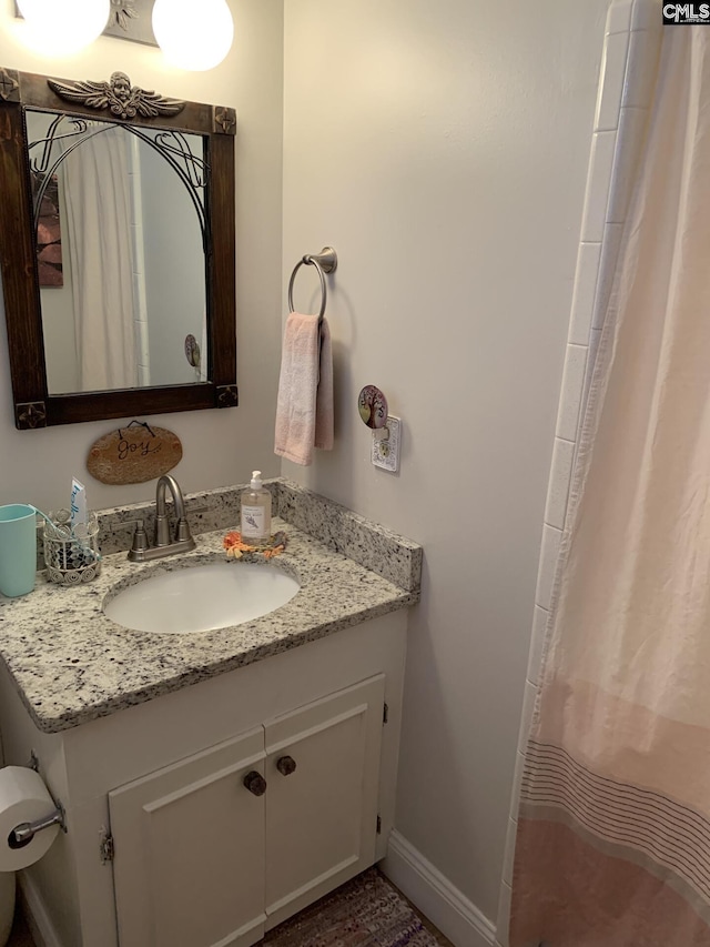 bathroom with walk in shower and vanity