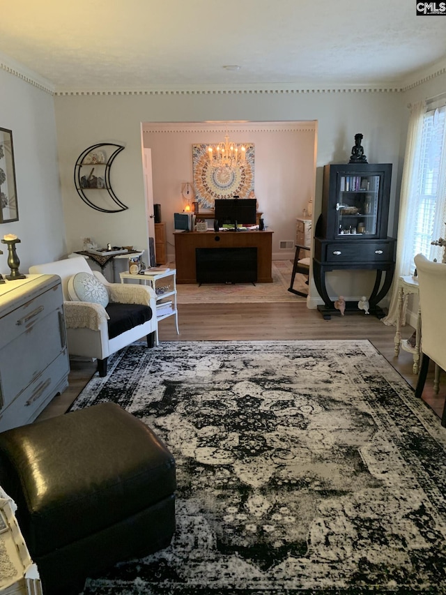 living room with hardwood / wood-style flooring and an inviting chandelier