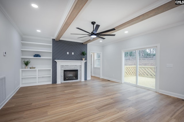 unfurnished living room featuring ceiling fan, beam ceiling, a tile fireplace, and light hardwood / wood-style flooring