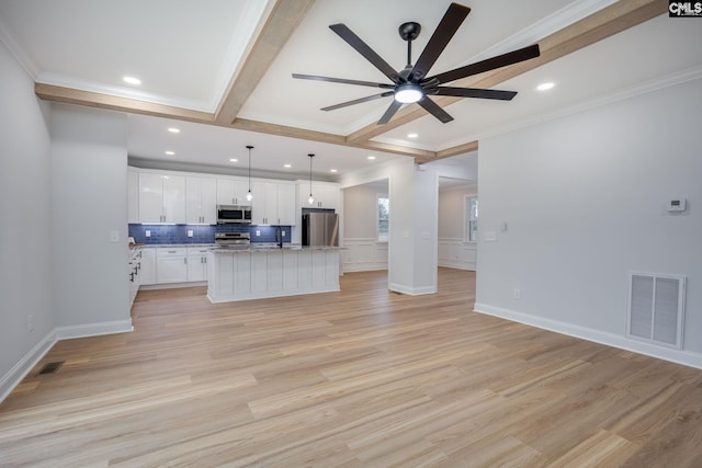 kitchen featuring white cabinetry, a kitchen island, pendant lighting, stainless steel appliances, and beam ceiling