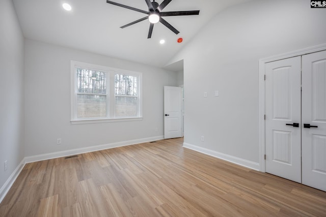 interior space with ceiling fan, lofted ceiling, and light wood-type flooring